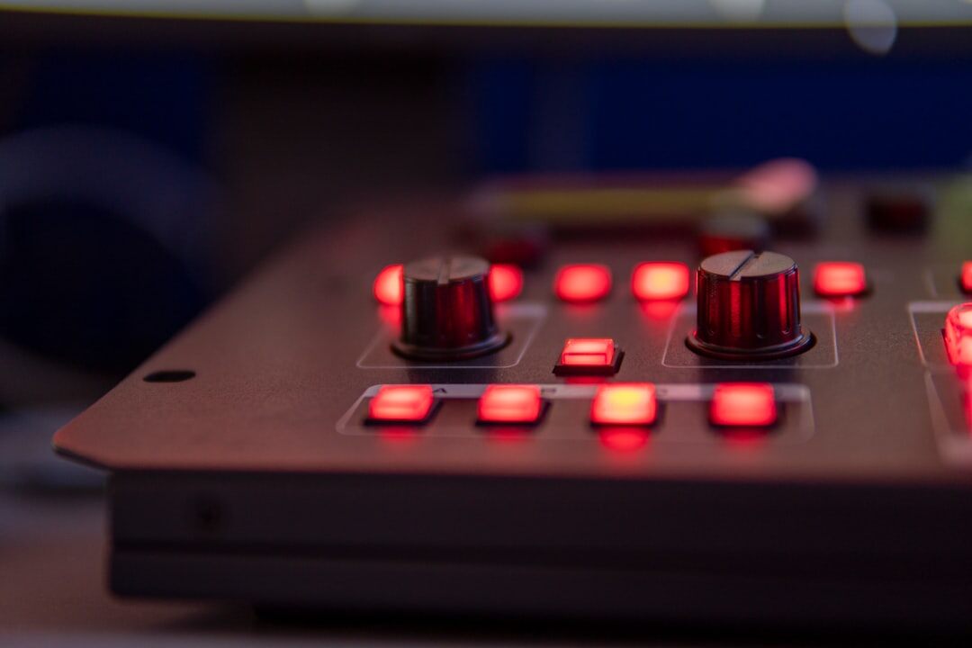 Close-up of a multi-camera video switcher panel with glowing buttons