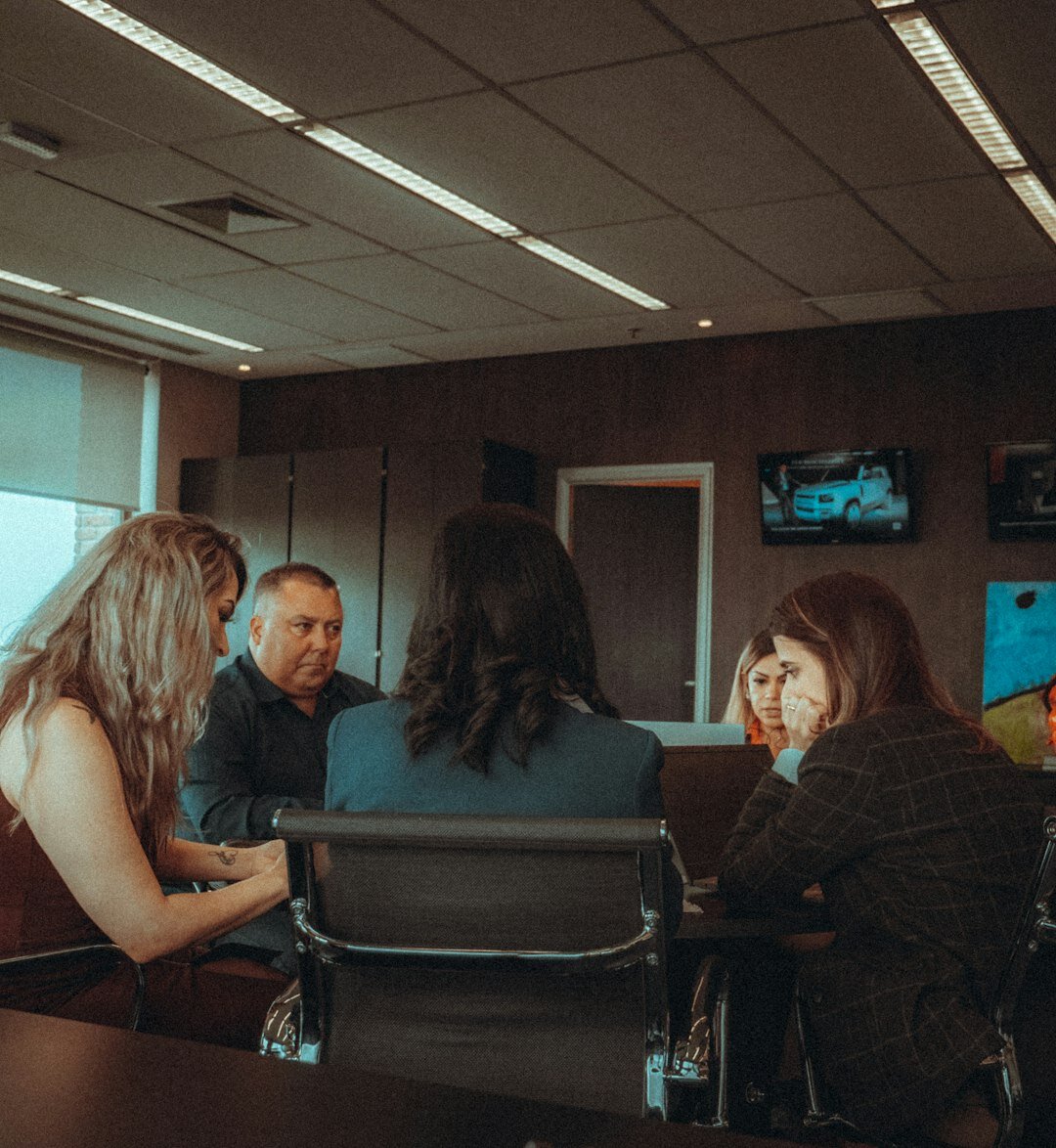 Trainees discussing a live production plan around a table